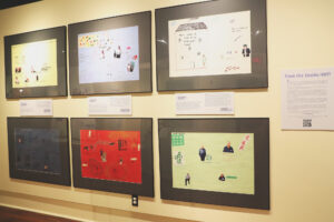 Framed art made by people who lived at Woodlands. Each piece contains illustrations, and clippings of photos with words describing each of their experiences, good and bad. 
